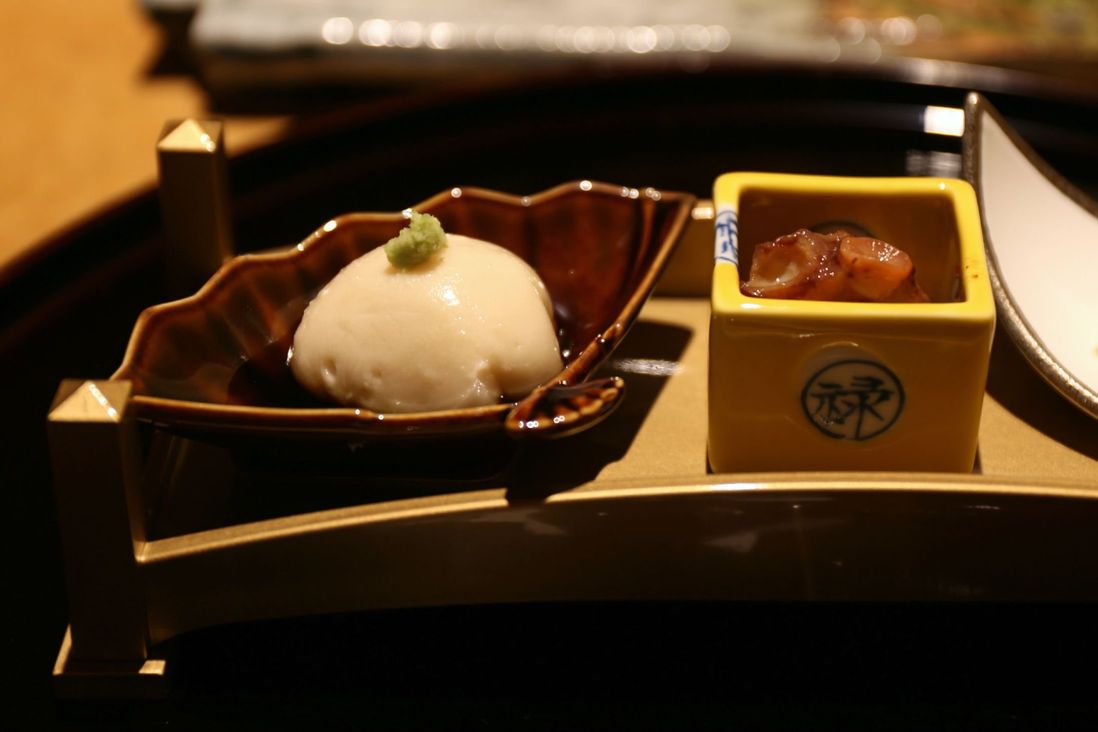 homemade sesame tofu topped with wasabi and dashi (L); simmered octopus sakura-ni (R)<br>